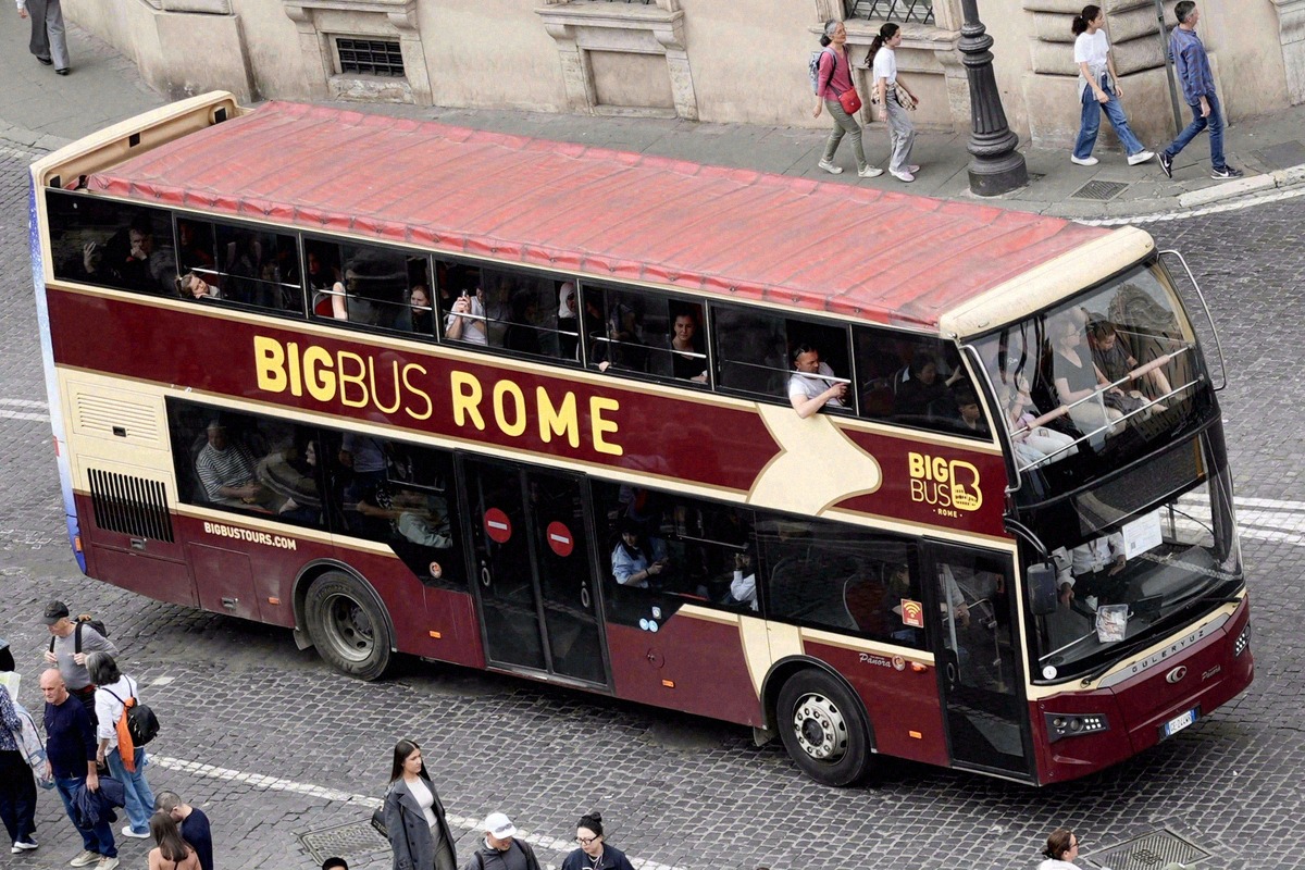 A red Big Bus hop-on hop-off double-decker in the streets of Rome.
